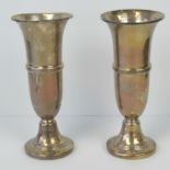A pair of HM silver bud vases, Birmingham 1966, weighted bases, each standing 16.5cm high.