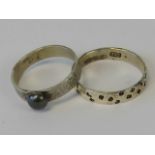 Two 925 silver rings; one with planished effect band and central ball,