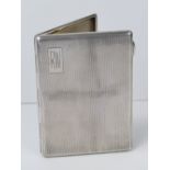 A HM silver cigarette case, engine turned pattern, gilded interior,