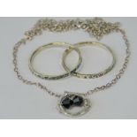 A suite of jewellery comprising pendant on silver chain and pair of planished effect rings,