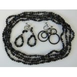 A long French jet necklace with two pairs of French jet screw back earrings,