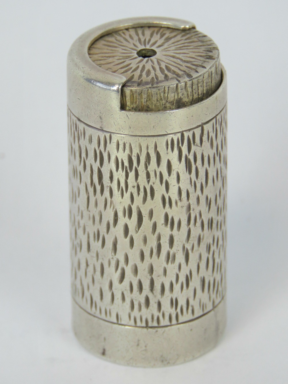 A HM silver bark effect coin holder, hallmarked London 1973, standing 4.9cm tall, 46.8g.