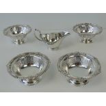 A set of four silver plated sweet meat dishes with thread pattern borders with shells and leaves