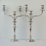 A fine pair of silver plated triple sconce candelabra, circular foot with a tapering knopped column,