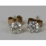 A pair of diamond stud earrings, each earring with single round brilliant cut diamond,