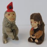 A clockwork wind up monkey with cymbals and red felt hat c1950s,