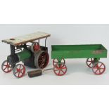 A Mamod scale model live steam traction engine, complete with single piston, spring-belt drive,