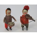 Two Schuco clockwork clowns playing musical instruments,