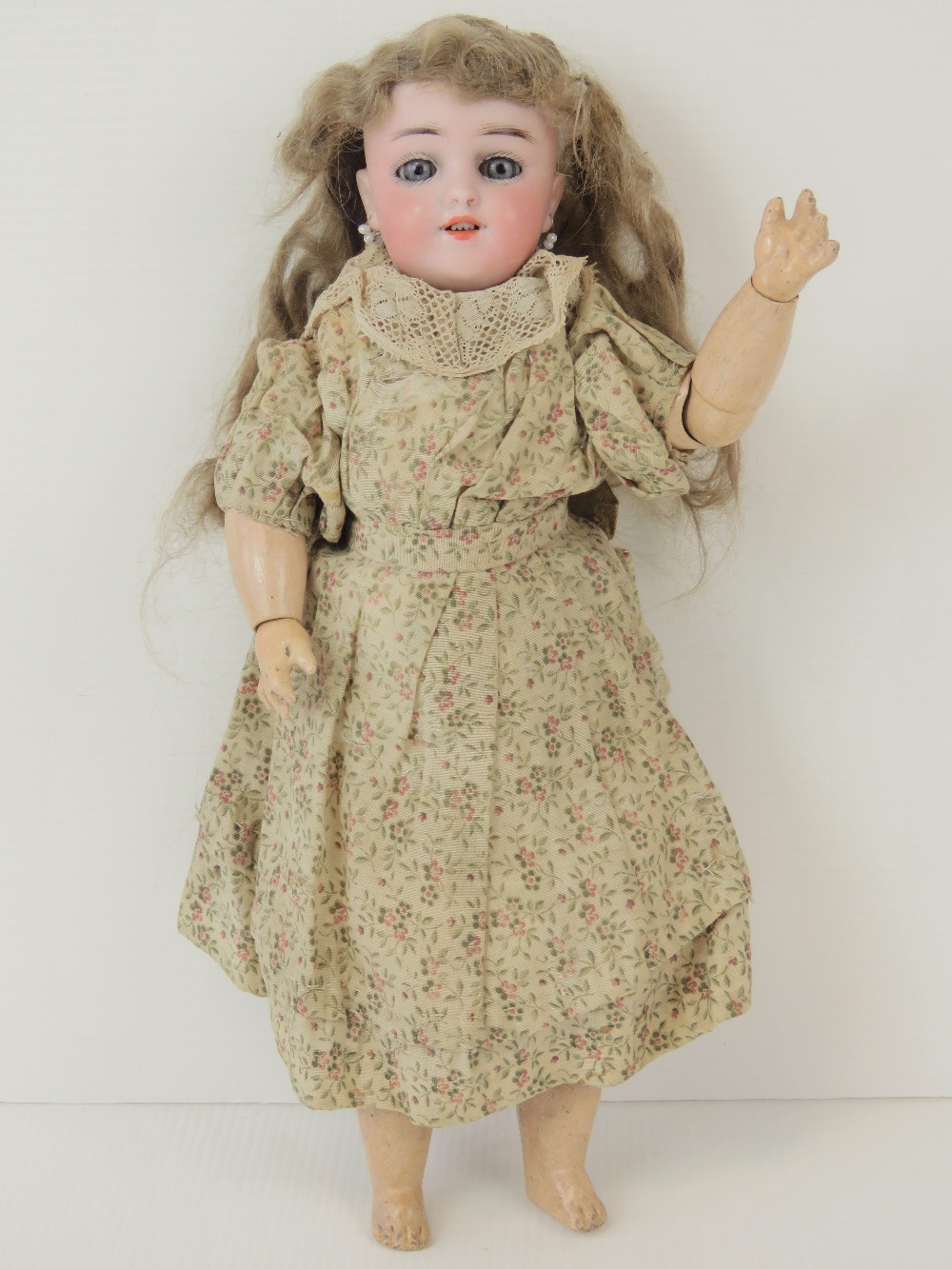 A late 19thC Karl Hartman Globe Baby bisque head doll, with grey glass sleep eyes,