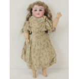 A late 19thC Karl Hartman Globe Baby bisque head doll, with grey glass sleep eyes,