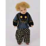 A miniature doll with bisque head, having composition body and movable limbs,