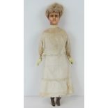 A vintage wax headed doll complete with lace garments, a/f, 36cm high.