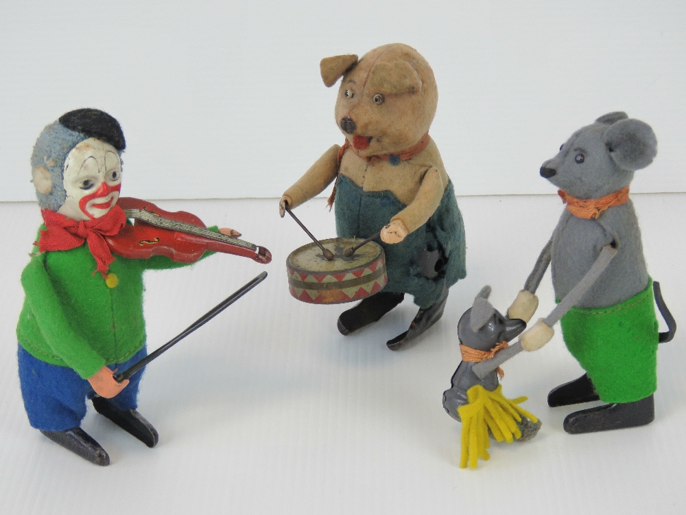 A clockwork wind-up felt-covered drumming pig figurine.