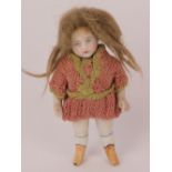 A miniature porcelain doll with bisque head, having painted features,