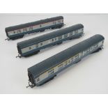 Three 00 gauge Triang passenger coaches in BR livery.