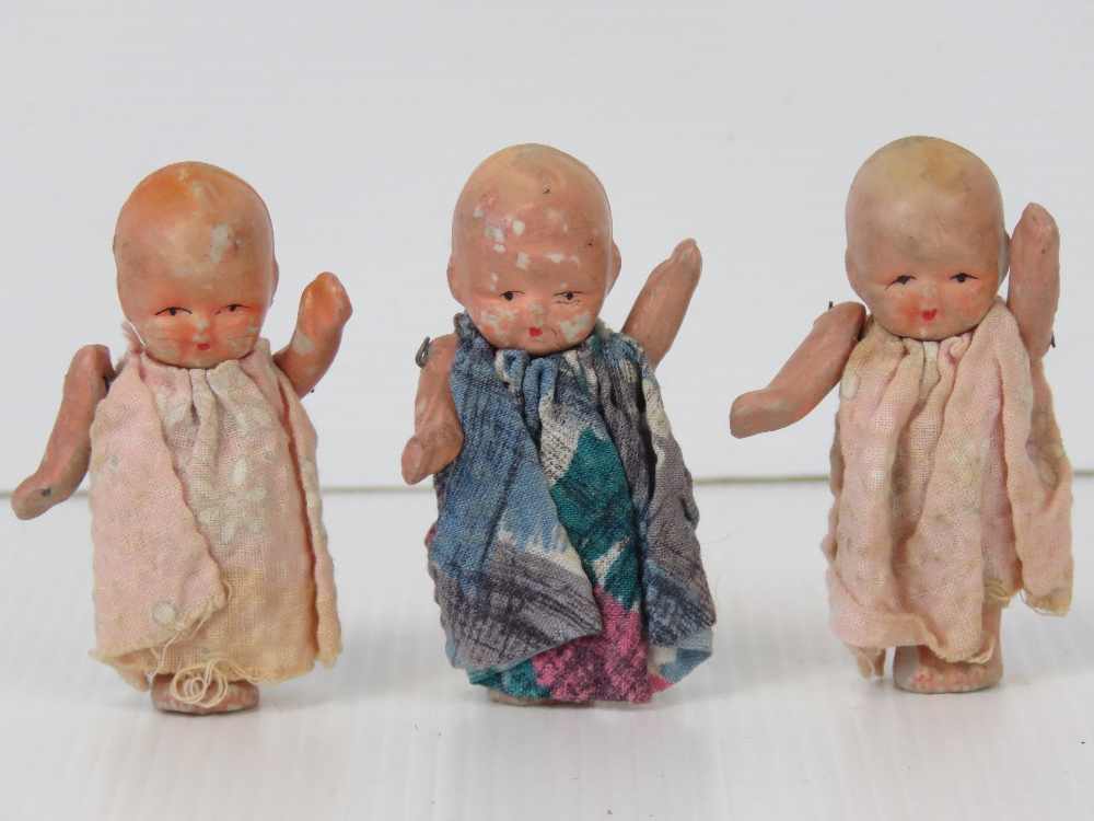 Three miniature porcelain baby dolls wit
