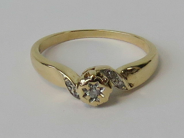 A 9ct gold and diamond ring, raised cent
