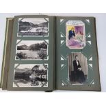 An Edwardian postcard album together wit