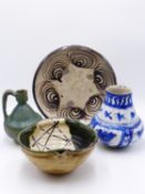 TWO FAR EASTERN POTTERY BOWLS, A GREEN GLAZED MIDDLE EASTERN EWER AND A BLUE AND WHITE VESSEL.