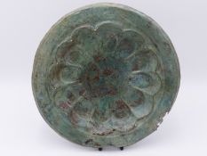 AN ARCHAIC PATINATED COPPER BOWL WITH SCALLOPED RECESSED CENTRE AND ENGRAVED DECORATION . 28 CM