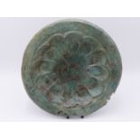 AN ARCHAIC PATINATED COPPER BOWL WITH SCALLOPED RECESSED CENTRE AND ENGRAVED DECORATION . 28 CM