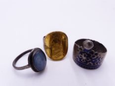 A MIDDLE EASTERN SILVER AND ENAMEL RING, A GOLD SOVEREIGN AND SILVER SHANK RING AND AN OPAL SET