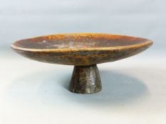 TWO AFRICAN TRIBAL LARGE CARVED BOWLS ON RAISED STEM. ONE WITH OLD IRON REPAIRS. 61 CM DIAMETER (2)