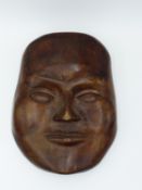 AN ORIENTAL CARVED MOOD MASK OR WALL PLAQUE