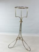 A SILVER PLATED WINE BUCKET/ ICE PAIL STAND ON SCROLL SUPPORTS 90 CM HIGH