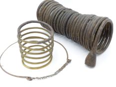 A LARGE COPPER COIL " CURRENCY" BRACELET PROBABLY IGBO PEOPLE, NIGERIA, WEST AFRICA, A BRASS COIL