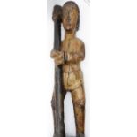 AN ANTIQUE CARVED WOOD FIGURE WITH POLYCHROME PAINTED DECORATION IN THE SPANISH COLONIAL MANNER.