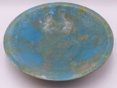 A LARGE MIDDLE EASTERN , POTTERY BOWL WITH TURQUOISE LUSTRE GLAZE. SHALLOW EMBOSSED DECORATION TO