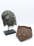 AN INTERESTING WEST AFRICAN TRIBAL PATINATED AND ENGRAVED MASK. MOUNTED ON DISPLAY STAND 19TH