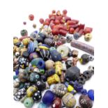 A COLLECTION OF ANTIQUE AND ARCHAIC GLASS AND OTHER BEADS INCLUDING MILLEFIORI EXAMPLES (QTY)