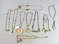 TWENTY TWO VARIOUS AFRICAN IRON AND STONE SET NECKLACES, SOME HUNG WITH IRON CURRENCY GONGS,