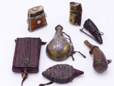 A PERSIAN BRASS AND SILVER DECORATED GUNPOWDER FLASK, TWO HORN POWDER FLASKS, AN AFRICAN WOODEN