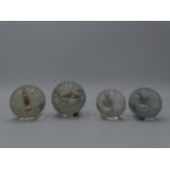 A GROUP OF FOUR RARE 19TH CENTURY GLASS SULPHIDE INCLUSION MARBLES TO INCLUDE A HORSE, A STANDING