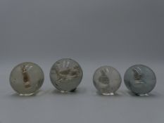 A GROUP OF FOUR RARE 19TH CENTURY GLASS SULPHIDE INCLUSION MARBLES TO INCLUDE A HORSE, A STANDING