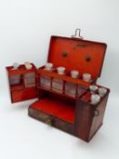 A 19TH CENTURY TIN TOLE WARE APOTHECARY'S CABINET, FITTED INTERIOR WITH TEN PERIOD GLASS BOTTLES.