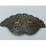 AN INDO PERSIAN STEEL AND SILVER GILT DAMASCENE BUCKLE COVER OR ORNAMENT OF PIERCED FOLIATE FORM