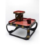 A JAPANESE TEA CEREMONY STAND AND ACCOUTREMENTS BLACK, RED AND GILT LACQUERED DECORATION. A