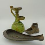 AN EARLY MIDDLE EASTERN IRON OIL LAMP, A GREEN GLAZED POTTERY OIL LAMP AND A COPPER OIL LAMP OF OPEN