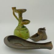 AN EARLY MIDDLE EASTERN IRON OIL LAMP, A GREEN GLAZED POTTERY OIL LAMP AND A COPPER OIL LAMP OF OPEN