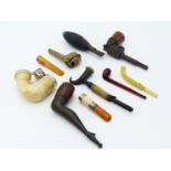 A SMALL CASED RED AMBER SMOKING PIPE, TWO AMBER AND MEERSCHAUM CHEROOT HOLDERS, A LONG ART DECO