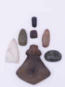AN CARVED STONE AXE, FIVE WORKED STONE TOOLS AND GREEN STONE PENDANT. THE AXE 13.5 CM LONG (7)