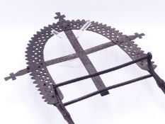 AN ANTIQUE WROUGHT IRON FOLDING BIBLE OR PRAYER STAND WITH PIERCED AND STAMPED DECORATION TOGETHER