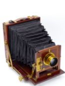 AN UN-NAMED VICTORIAN MAHOGANY AND BRASS BOUND 1/2 PLATE CAMERA, FITTED WITH COOKE LENS H.D. TAYLORS