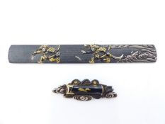 A JAPANESE KOZUKA SWORD MOUNT DECORATED IN GOLD AND SILVER WITH PURSUING SAMURAI WARRIORS AND