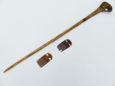 A LONG BONE HAIR PIN WITH STAINED AND CARVED DECORATION TOGETHER WITH TWO SMALL BONE COMB
