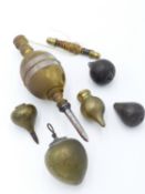 A LARGE BRASS AND STEEL PLUMB BOB WITH CORD AND SPINDLE TOGETHER WITH FIVE FURTHER BRASS, BRONZE AND